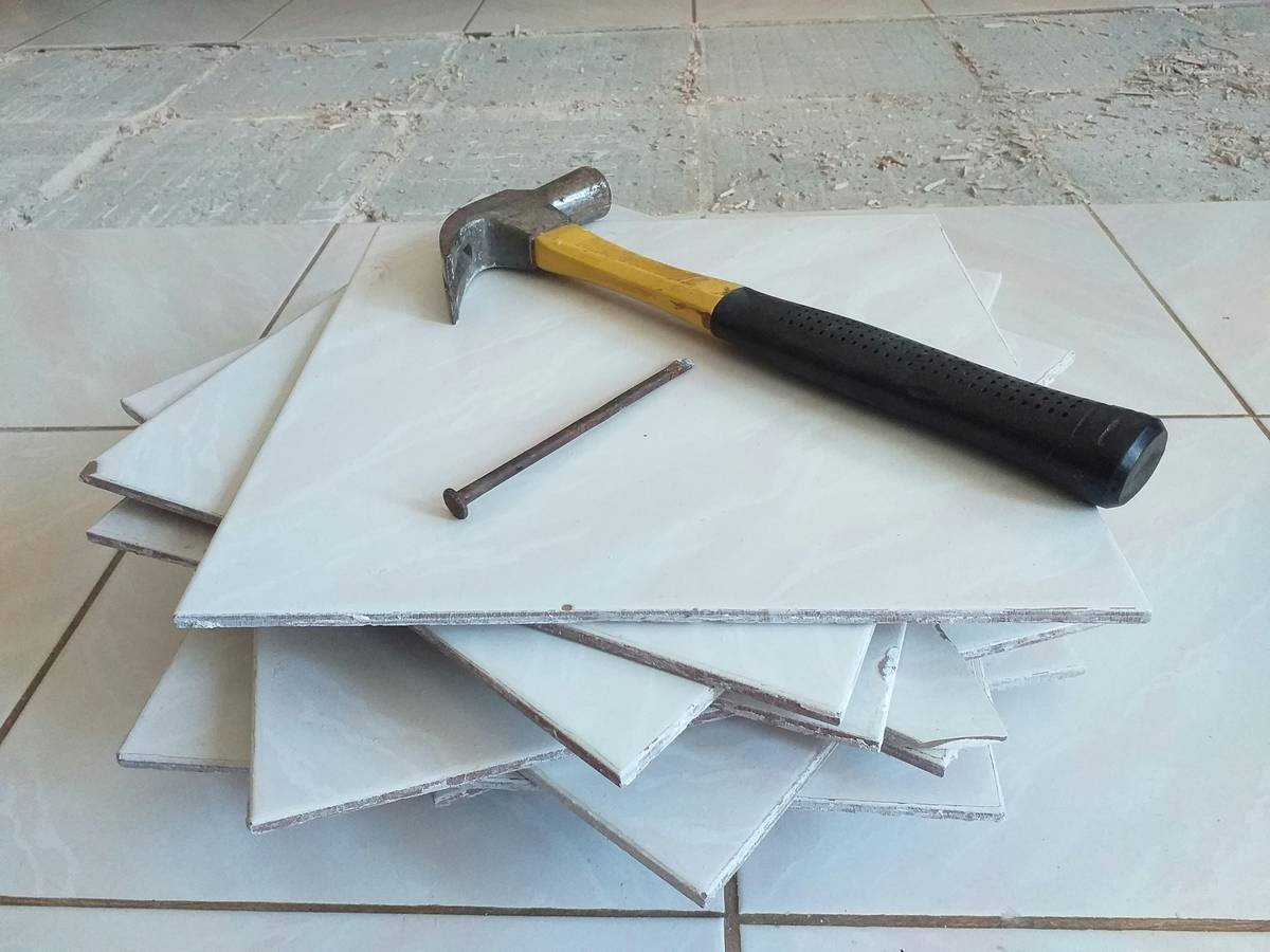Bar chart comparing cost per sq ft of adhesive vinyl vs LVP vs ceramic tile vs hardwood, showing adhesive vinyl as most affordable at $1.89/sq ft