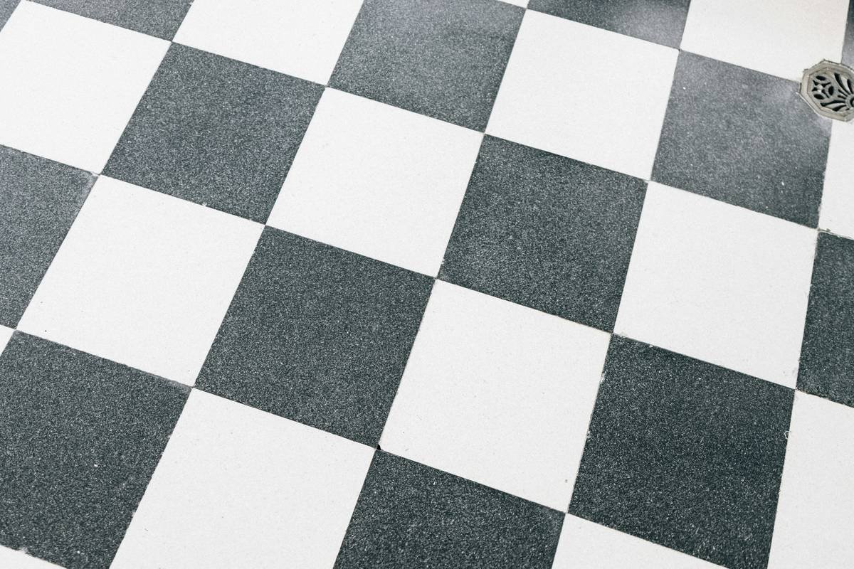 Comparison chart of adhesive flooring types: pressure-sensitive, releasable, and permanent urethane adhesives with VOC levels and ideal use cases