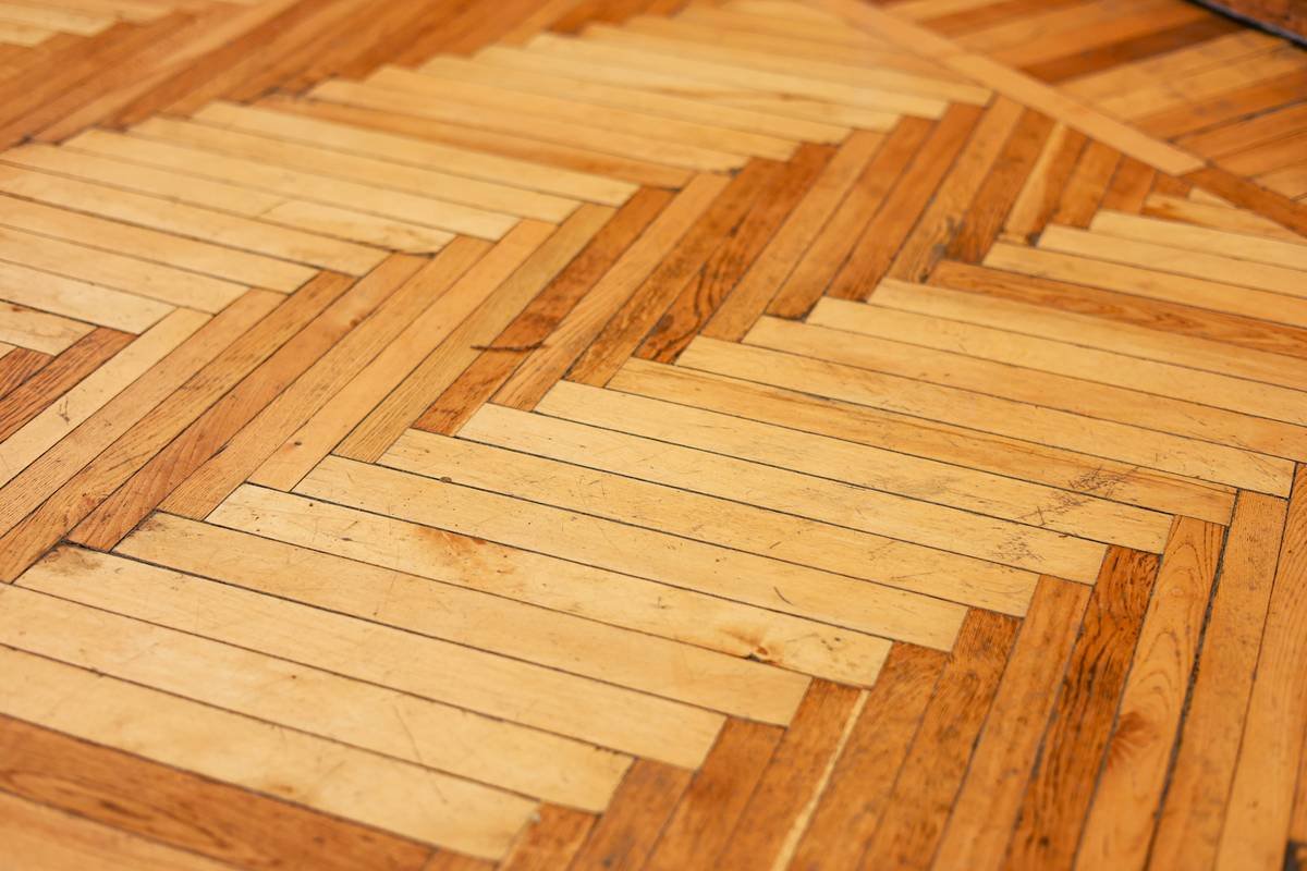Infographic showing true cost breakdown of adhesive flooring: materials 55%, subfloor prep 25%, tools 10%, waste/contingency 10%